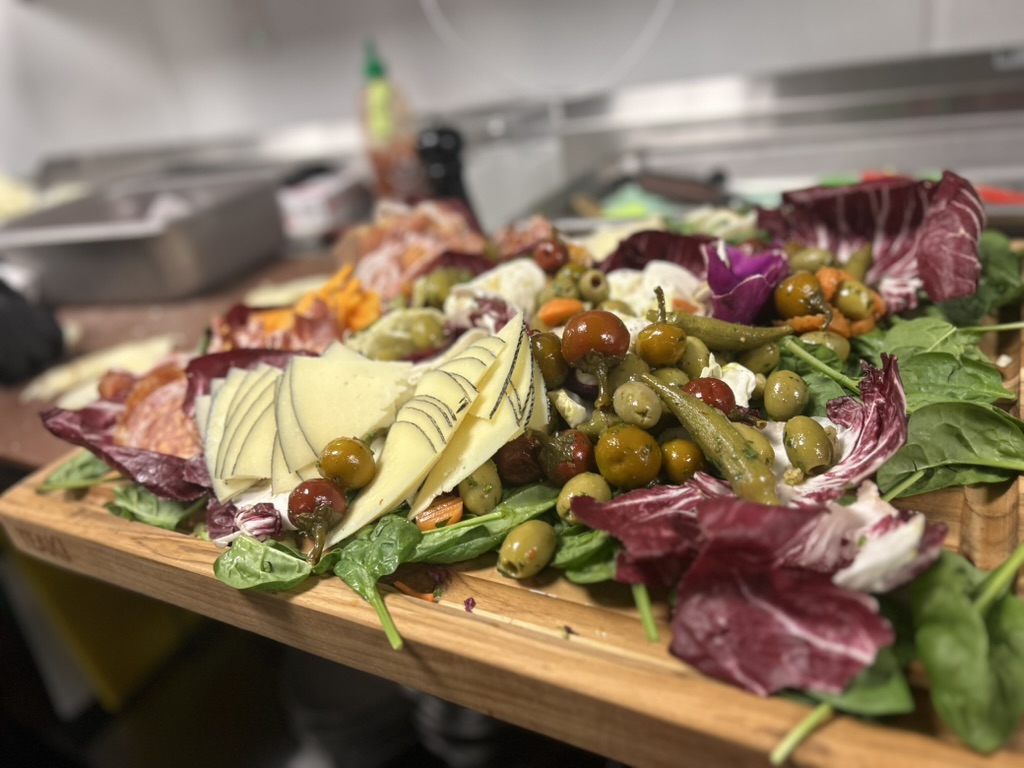 Antipasto board with cured meats, cheese, olives and radicchio