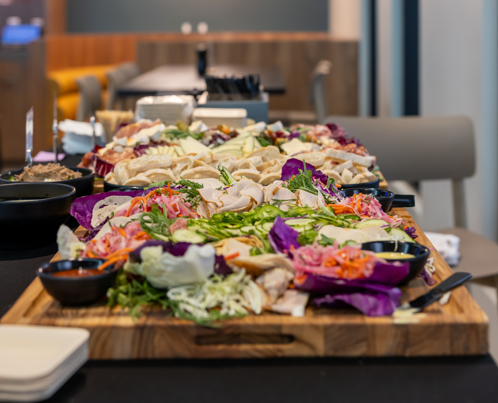Large banh mi style grazing board with sliced meats and pickled vegetables
