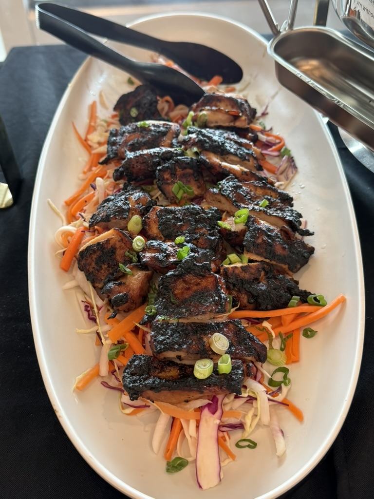 Charred chicken over slaw and greens