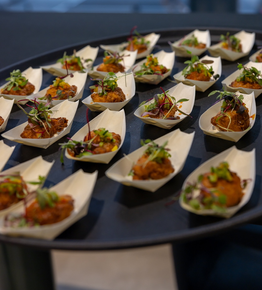 Plated fried chicken bites with microgreens for passed service