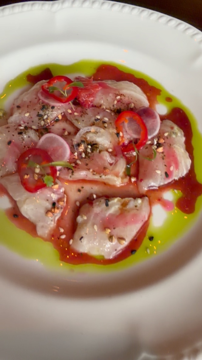 Fish crudo with chili, radish and herb oil