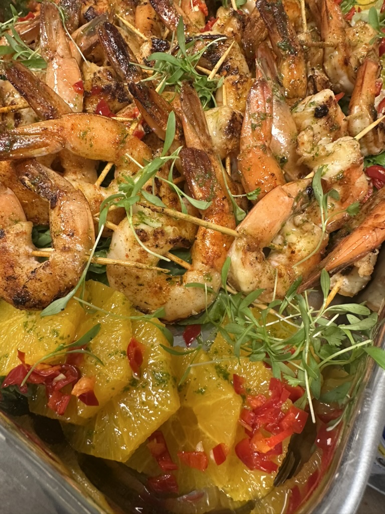 Grilled shrimp skewers over citrus and chili