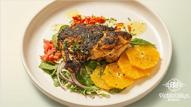 Jerk chicken breast with citrus and mint over slaw