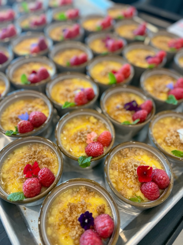 Lemon posset cups with raspberry, crumble and edible flowers