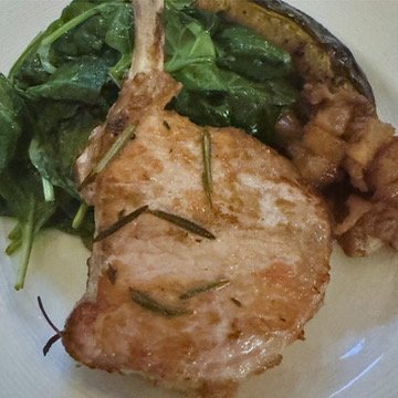Rosemary pork chop with braised apples and sauteed greens